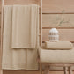 Serviettes de bain en éponge unie beige